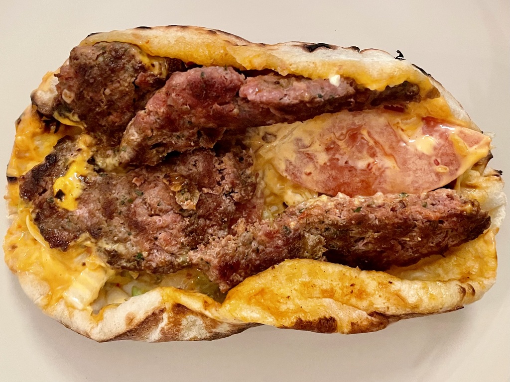 <em>Naan kefta</em> with <em>sauce algérienne</em>. The naan is filled with a nondescript cheese, which seems to be the thing in this part of France. It may not look pretty, but it’s delicious.