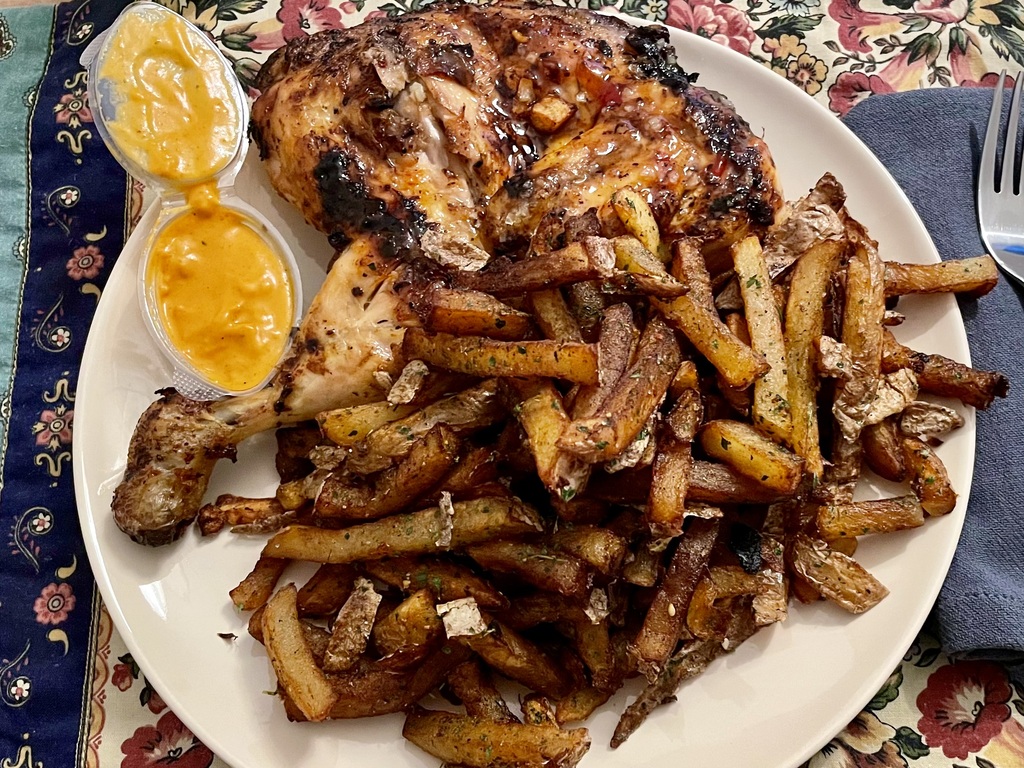 Braised chicken, chef’s sauce, lots of fries, and no fresh vegetables whatsoever.