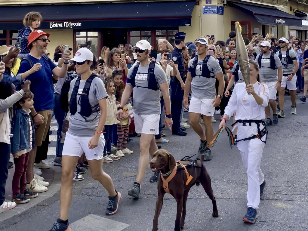 The Olympic torch passing through the streets of Montpellier. I have no idea who the athlete is or why she was being dragged by a dog.