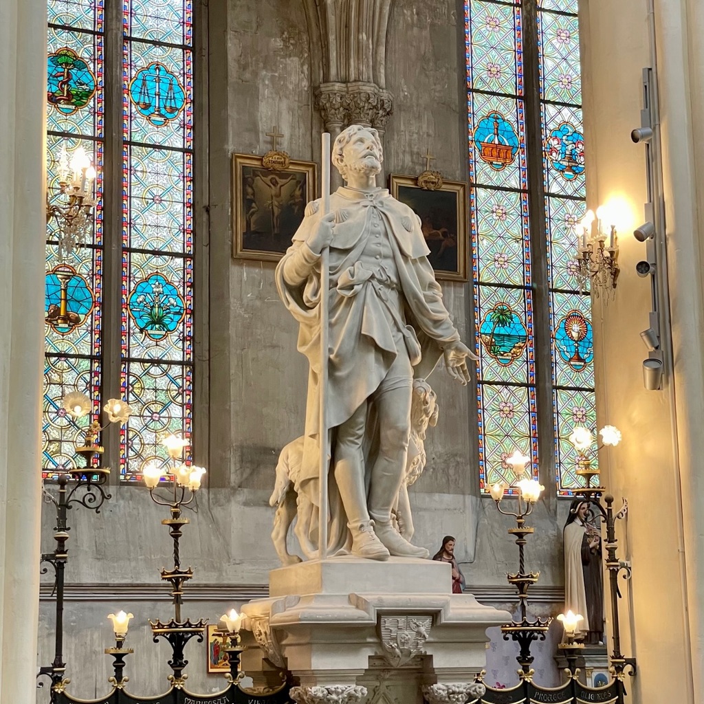 A statue of the patron saint of Montpellier, St. Roch, at his shrine. He is often depicted with an open sore on his leg, but here he has a visible bandage.
